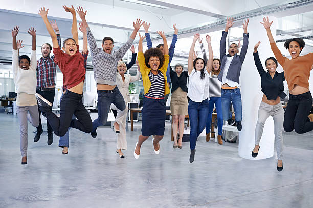 positive work environment - Shot of office staff jumping