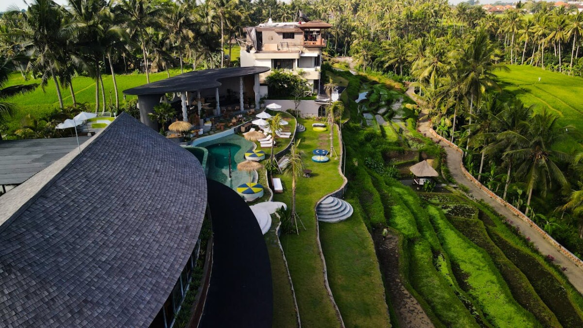 a luxury villa in bali surrounded by rice paddies.
